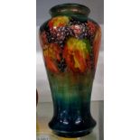 An early 20th Century Moorcroft flambe leaf and blackberry vase - impact mark and crack to shoulder