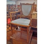 A pair of Edwardian inlaid mahogany shield back elbow chairs with upholstered backs and seats (one