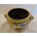 An antique Chinese bronze censer, decorated with lion mask handles with ring foot