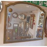 A 1930's gilt framed wall mirror with applied composite bosses and leopard decorated panel to shaped
