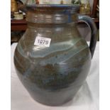 A large studio pottery jug with impressed seal mark to base of handle