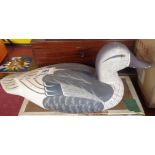 A carved wood decorative decoy duck