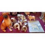 Six pottery bulldog figurines, a boxer dog, and a plaque