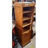 A 16 3/4" oak and mixed wood tambour fronted five shelf filing cabinet with panelled sides and key -