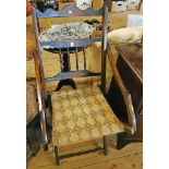 A late Victorian stained beech framed campaign style folding elbow chair with spindle back and slung