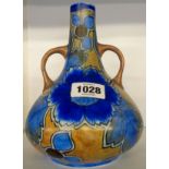 A 1930's Chameleon Ware two handled bottle vase decorated with stylized flower heads in blues and