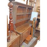 A 5' 20th Century oak two part dresser with central pillar to the two shelf open plate rack over a
