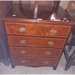 A 25" Edwardian mahogany and strung chest of four long drawers, set on bracket feet