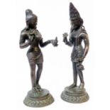 A pair of Indian weighted cast bronze deity figures