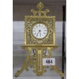 An old cast brass easel timepiece with movement marked for The British United Clock Co., with