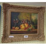 A gilt gesso effect framed reproduction oil on panel still life, with fruits and goblet on a table -