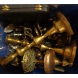 A box containing a quantity of metalware including brass candlesticks, brass table bell (a/f),