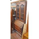 A 29" early 20th Century oak two part bureau bookcase with leaded glazed panel doors to top, part