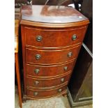An 18 1/4" reproduction walnut bow front chest of five long drawers, set on short cabriole legs with