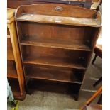 A 24" early 20th Century stained oak five shelf open bookcase, set on bracket feet - for re-