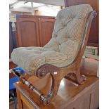 A Victorian stained mahogany framed slipper chair with button back upholstery and swept frame with
