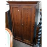 A 4' 4" early Victorian pitch pine double wardrobe with hanging space and long deep drawer