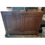 A 3' 11" late Victorian mahogany sideboard with two doors enclosing slides and shelves, rounded