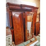 A 6' 9" Victorian mahogany break front triple wardrobe with moulded cornice and slides and drawers