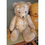 A vintage straw filled teddy bear