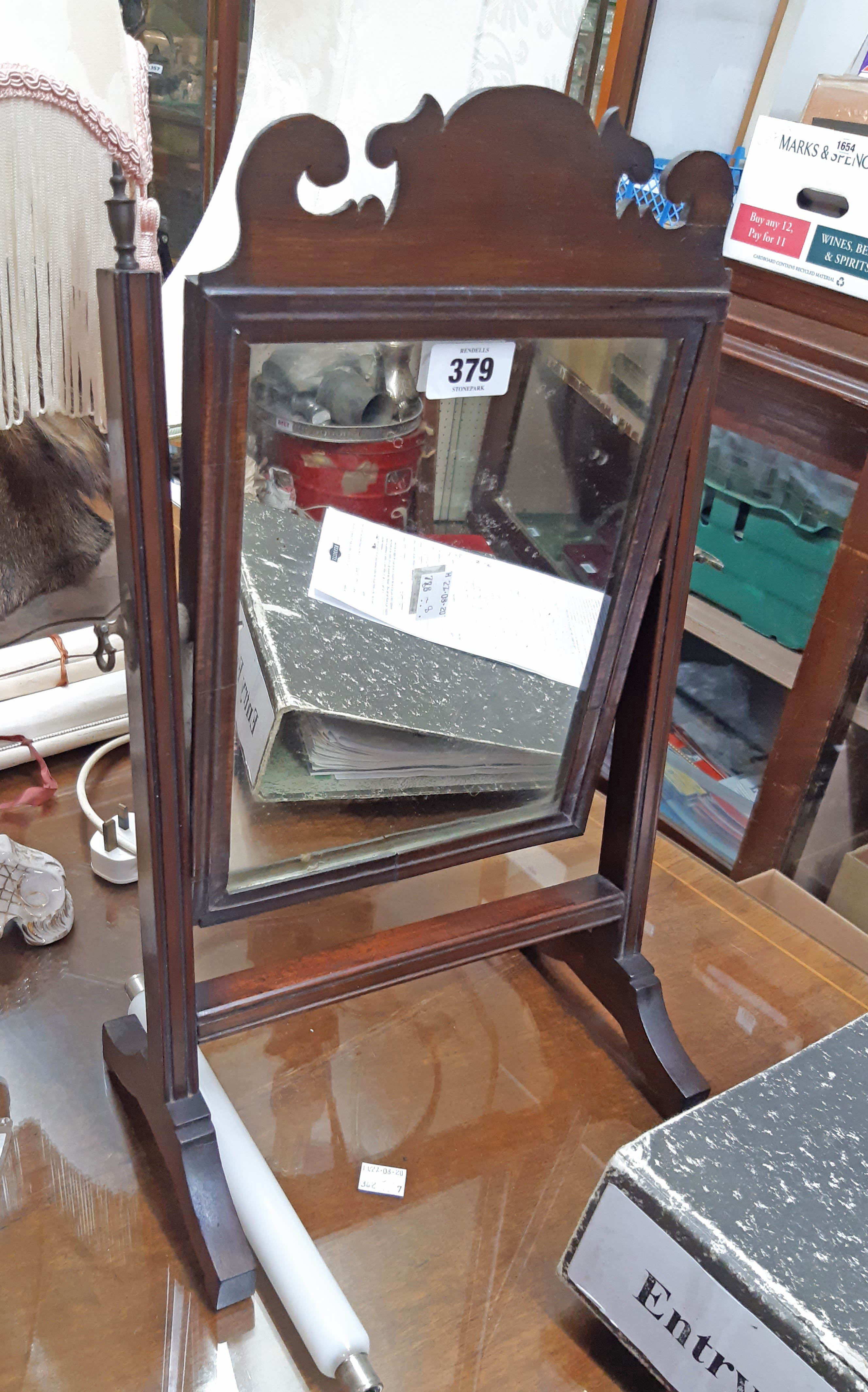A small 19th Century mahogany framed swing mirror with fret-cut pediment and moulded supports -