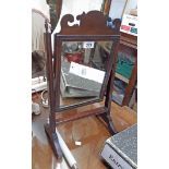 A small 19th Century mahogany framed swing mirror with fret-cut pediment and moulded supports -