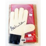 A Puma goalkeeper glove signed by Bob Wilson