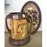 A Bretby art pottery wall plaque with Japonesque scene, and a two handled pottery mug with faux