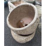 A pair of circular garden planters with swag decoration