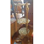 A 20th Century decorative brass three tier jardiniere stand with pierced surfaces and cast supports