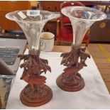 A pair of Black Forest carved wood spill holders with mountain goat figures and glass trumpets