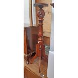 A varnished hardwood jardiniere stand with tester style pillar and quadruple bracket legs