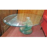 A 3' 9" 1970's design Italian glass coffee table with milled edge to oval top, set on a metal