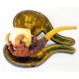 A cased Meershaum pipe in the form of a dragon claw holding the bulb with amber mouth piece