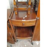 A vintage stained mixed wood two tier tea trolley with drawer and moulded supports