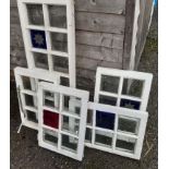 Five old casement windows, some with blue stained panels