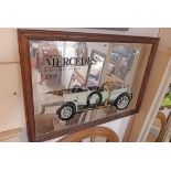 A stained wood framed reproduction Mercedes advertising mirror, depicting the 1908 Edwardian Tourer