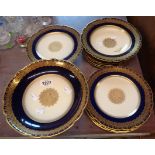 A 20th Century Limoges dessert set decorated with gilt and navy blue on an ivory ground comprising