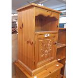 A modern pine bedside cabinet with decorative panel door - sold with a Stag style bedside table