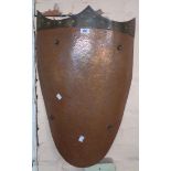 A large beaten copper and brass decorative wall shield