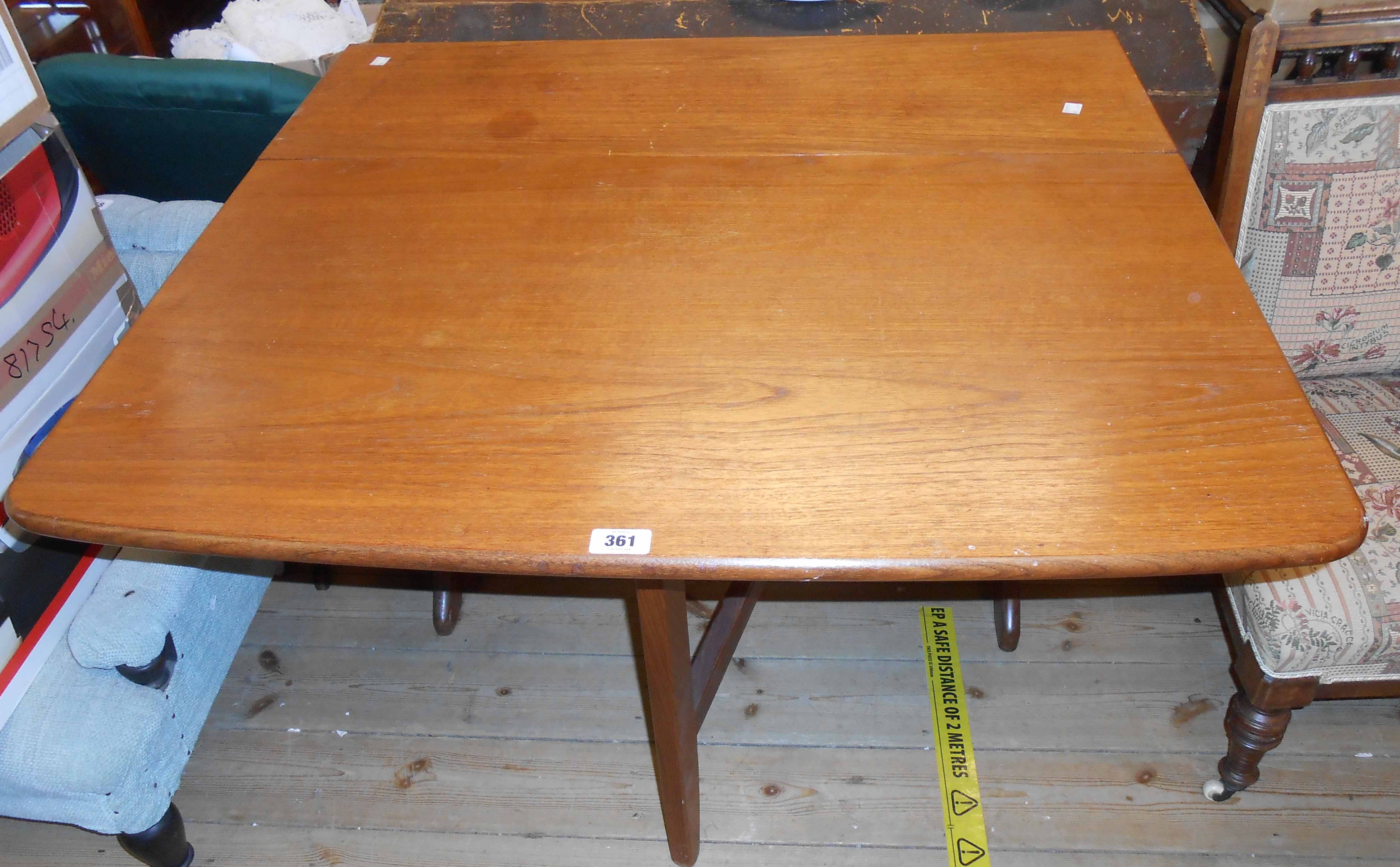 A 36" retro G-Plan style teak effect drop-leaf dining table, set on shaped standard ends - some edge