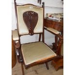 An Edwardian walnut framed campaign style folding chair with ornate pierced splat back and
