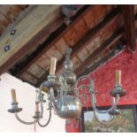 A brass six branch chandelier with double headed eagle finial