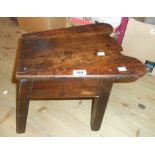An antique mahogany cock fighting type stool with frieze drawer, set on moulded square legs