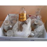Thirteen chemist drug bottles with lids