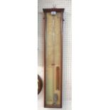 An old stained wood cased Admiral Fitzroy barometer with printed backboard, mercury tube and