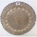 A 16" diameter Anglo-Indian soft white metal ornate charger with pierced and embossed decoration -