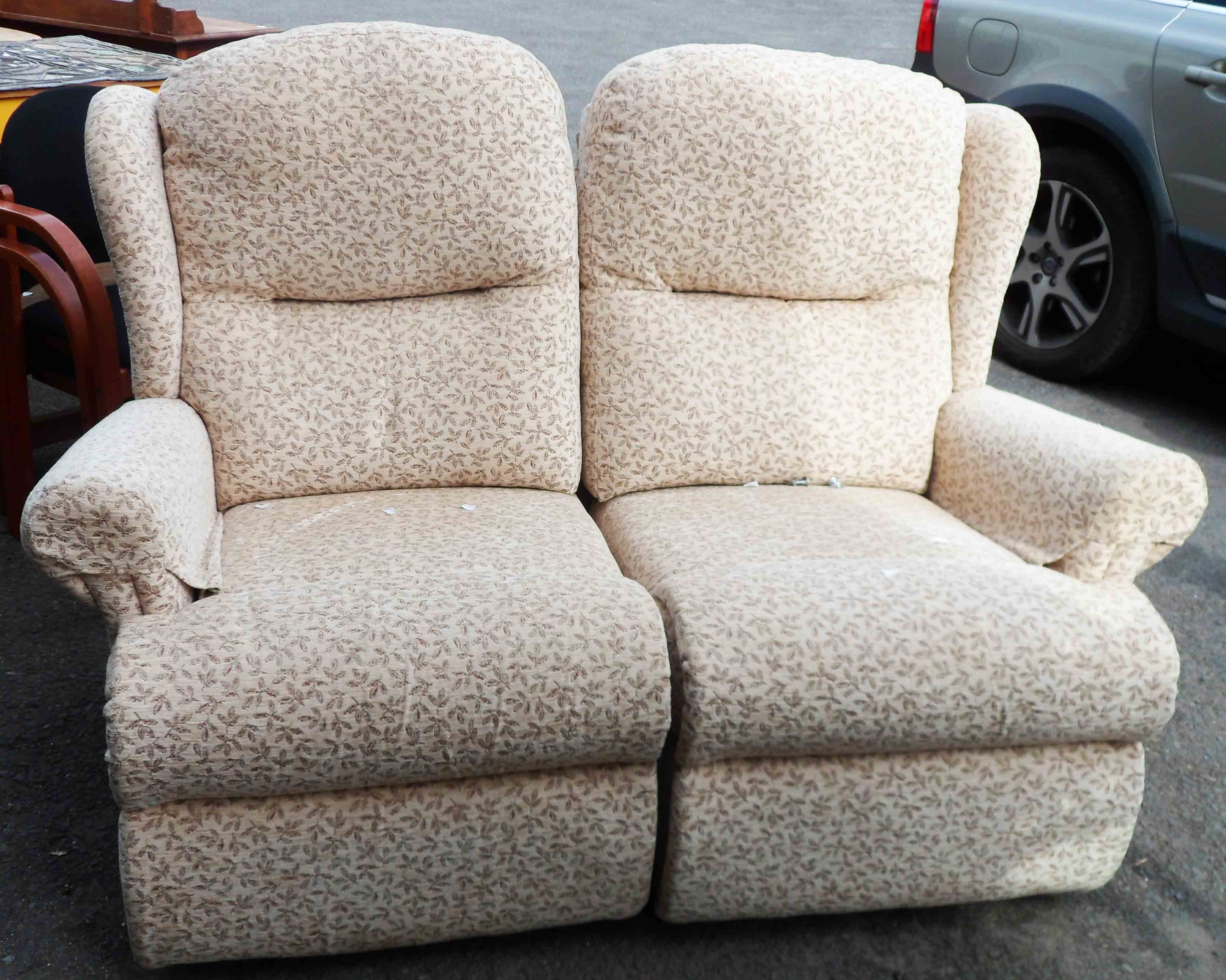 A modern upholstered two seater reclining settee