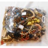 A bag containing a quantity of assorted costume jewellery