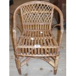 A vintage wicker child's club chair - some rebinding and old worm damage